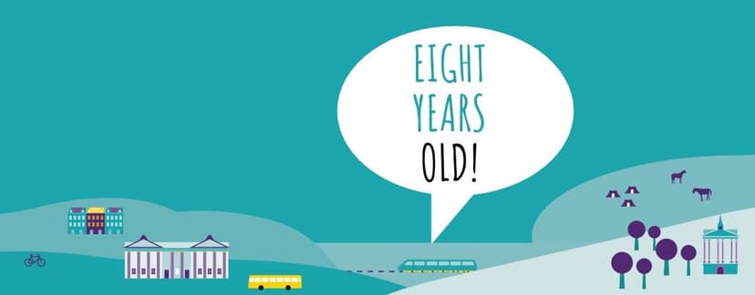 A city graphic illustration with buildings, trees, animals and public transport with text that reads: "Eight Years Old"