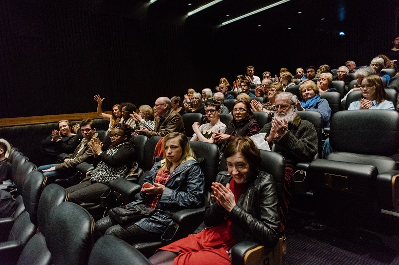 Photo of visible cinema audience.